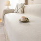 Chenille herringbone sofa cover styled on cushions in a living room
