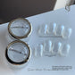 Two jars of crystal chrome nail powder with glossy mirror swatch nails on white