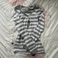 Striped henley top in gray and white laid on a floral cloth, option photo for size L