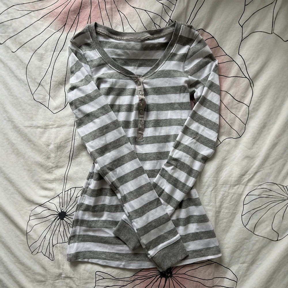 Striped henley top in gray and white laid on a floral cloth, option photo for size L