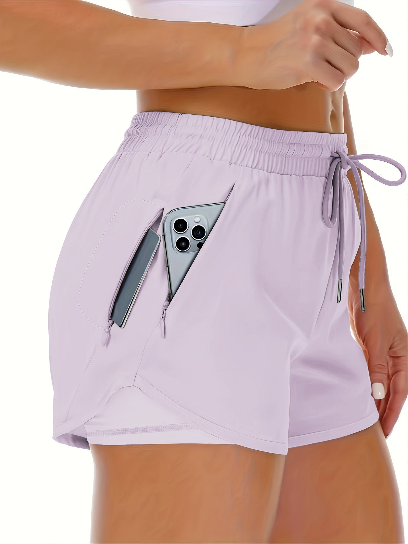 A blue side view of womens running shorts showing the phone pocket holding a phone (2)