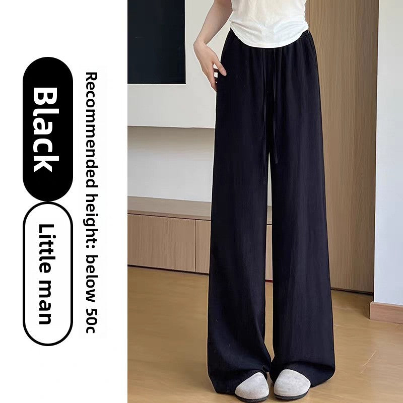 Womens high waist wide leg linen blend drawstring trousers, styled with a knit tank for a warm weather look