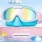 Swimming goggles with a soft silicone seal and adjustable strap in a two tone frame
