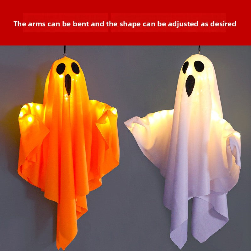 Orange and white fabric ghost hanging lamps glowing warm white with arms bent into a floating pose