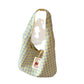 Single wide shoulder strap on a soft plaid canvas shoulder bag