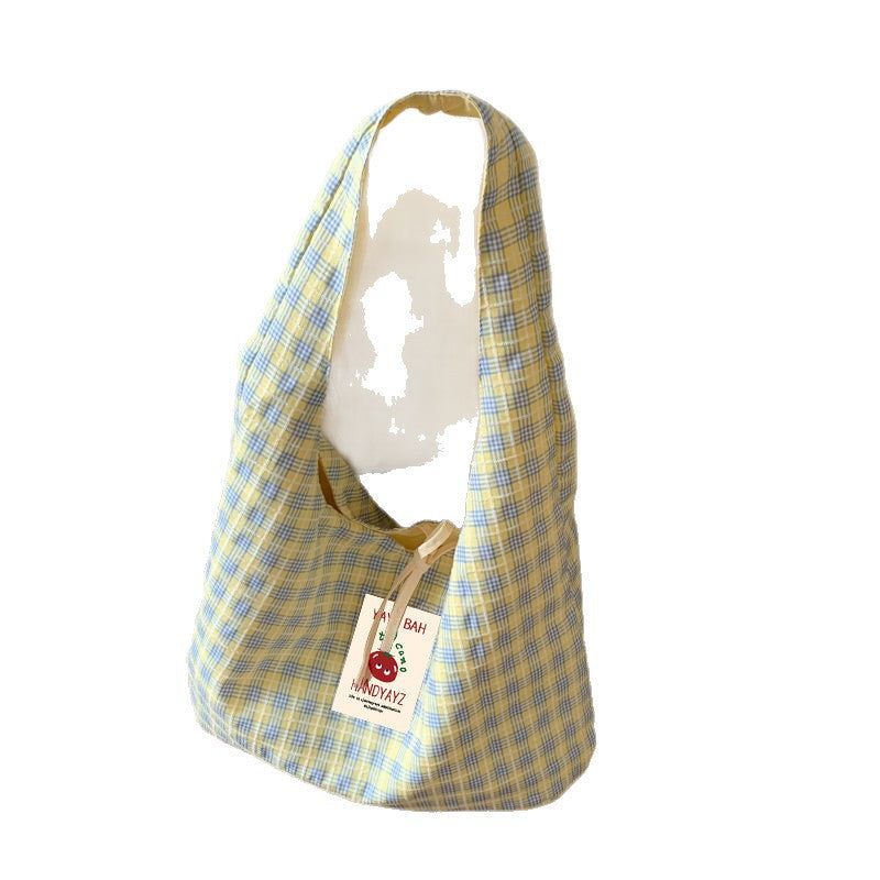 Single wide shoulder strap on a soft plaid canvas shoulder bag