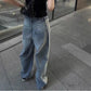 Washed black baggy denim jeans shown from the back with two rear pockets