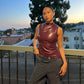 Front view of the sleeveless faux leather mock neck top with side ruching