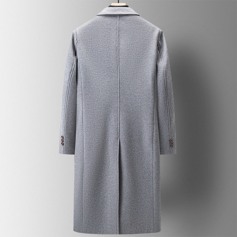 Back of a grey long coat on a hanger showing the centre back slit and three buttons at the cuff