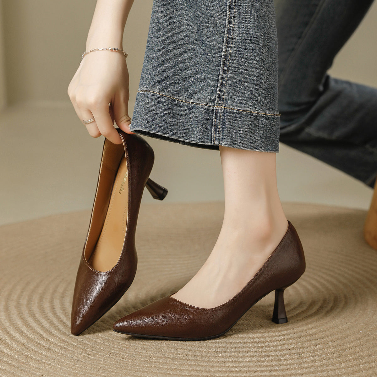 Brown pointed toe pumps with a 6 cm slim heel, one held in hand, Brown 6cm option, size 39