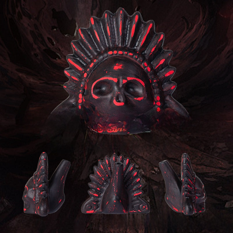 Red and black ceramic skull death whistle with feather headdress shown with front and side views
