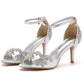 Stiletto sandal with an open toe, covered heel counter and a rhinestone decorated vamp