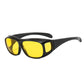 Yellow lens wraparound driving glasses with black frame and side panel on a white background
