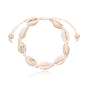 Cowrie shell anklet on a white knotted cord with sliding tie ends and two bone tone beads