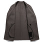 Inside of the camel toned double faced wool overcoat showing stitched edges and welt pockets