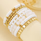 Stretch beaded bracelet set layered beside a watch on the same wrist