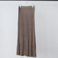 Deep camel taupe brown ribbed knit skirt with knit waistband hanging on a white hanger