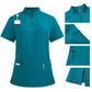 Womens scrub top in sapphire blue shown flat to display the stand collar, quarter zip and hip pockets
