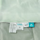 Close view of the sewn care labels along the piped edge of the summer coverlet