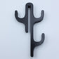 Black resin three hook with three arms, seen from the front on a light background