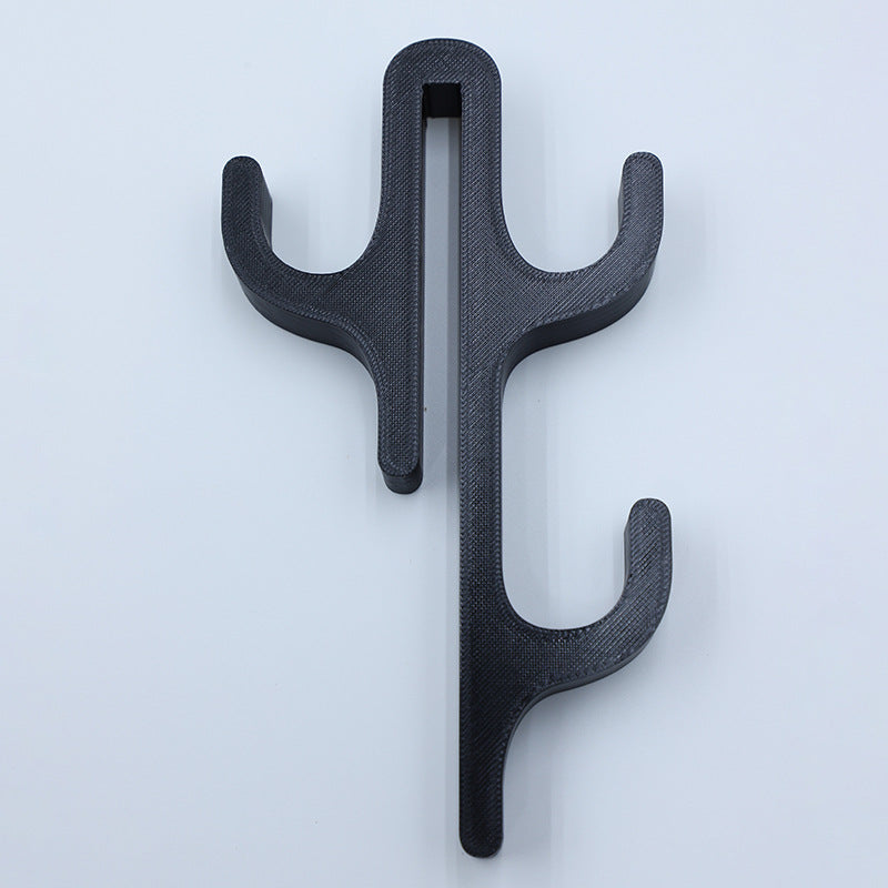 Black resin three hook with three arms, seen from the front on a light background