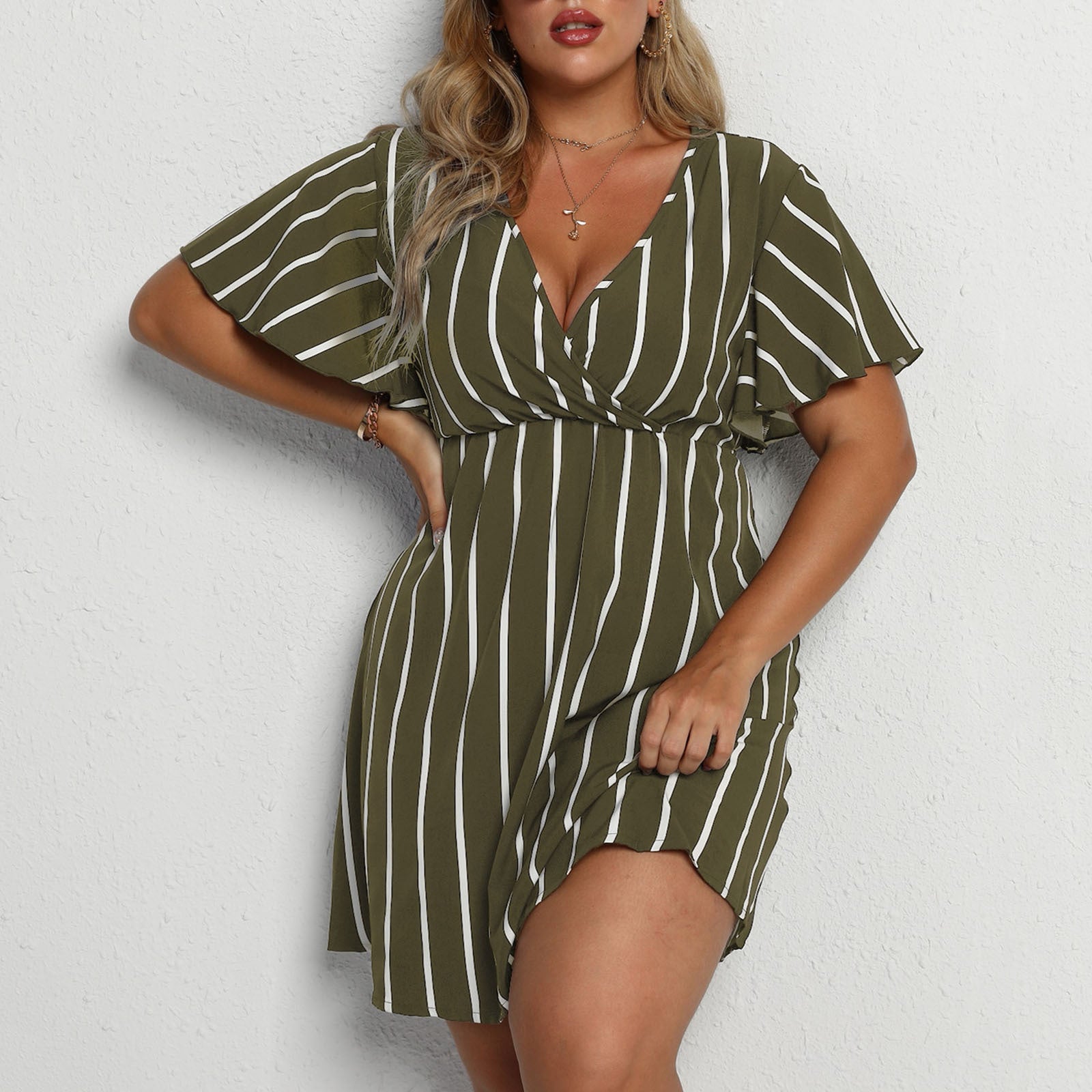 Army green and white striped surplice mini dress with flutter sleeves, worn front view