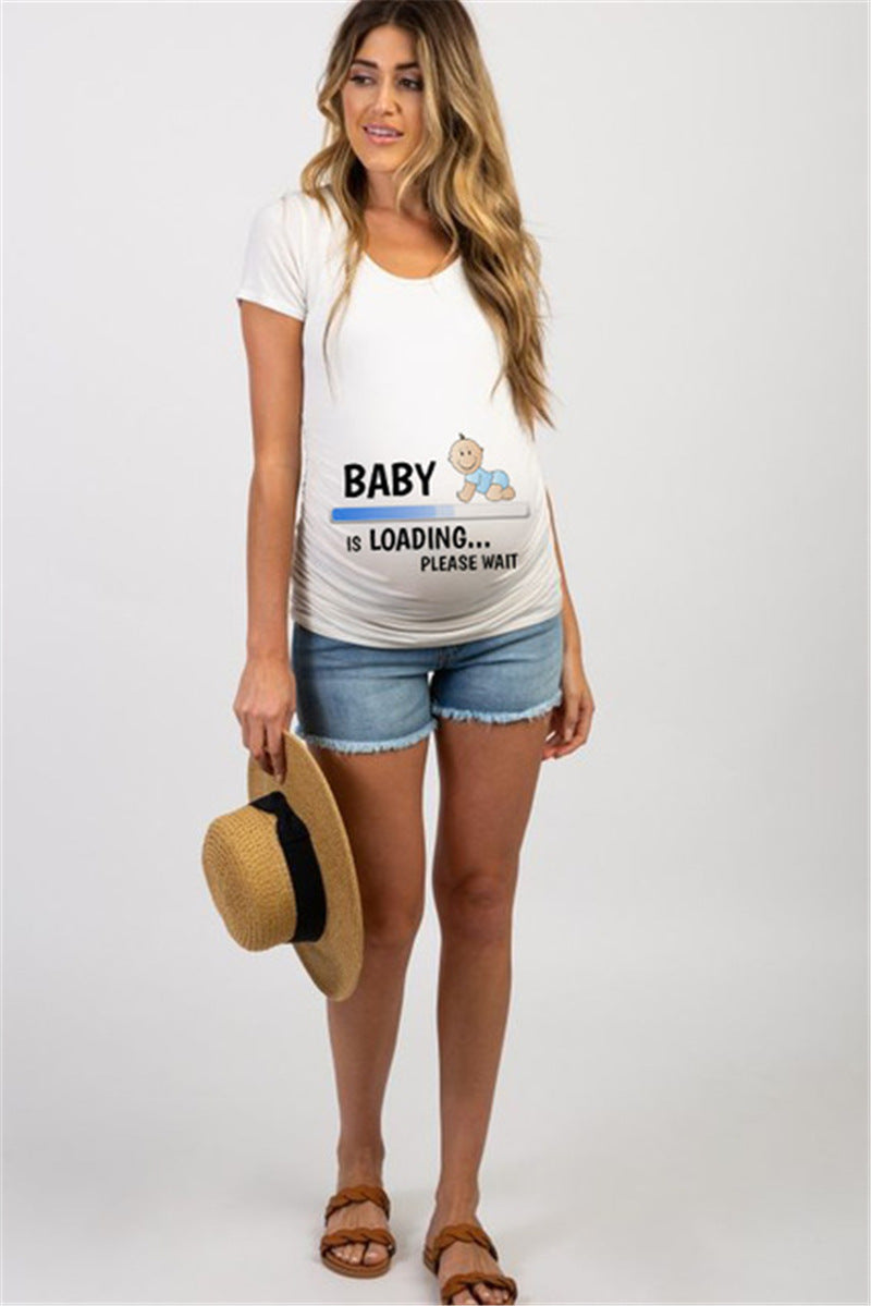 White maternity short sleeve tee with a Baby is Loading print, round neck and side ruching, on a pregnant model