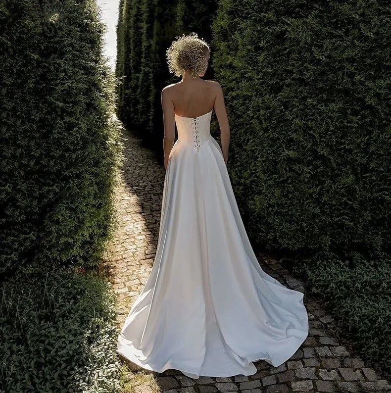 Sweetheart neckline of a strapless white satin bridal gown, close view