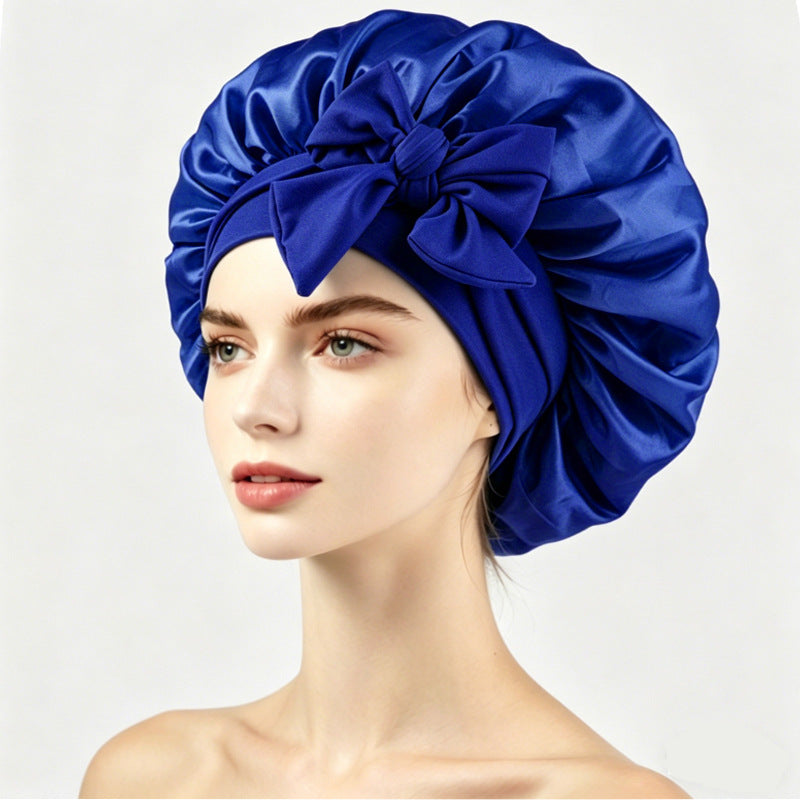 Adjustable satin bonnet with tie straps, worn to protect hair overnight