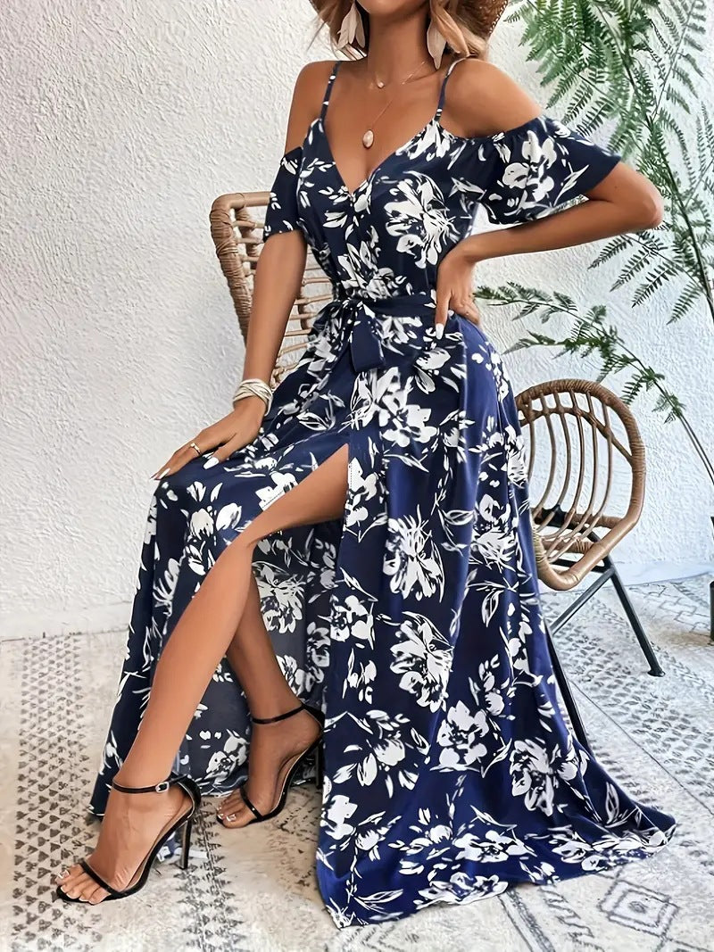 Floral maxi dress showing flutter sleeve and V neckline against a plain wall