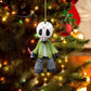 Masked horror figure acrylic ornament hanging on a lit Christmas tree with red baubles