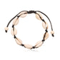 Black cord cowrie shell anklet laid flat, showing shells held by knots along the whole length