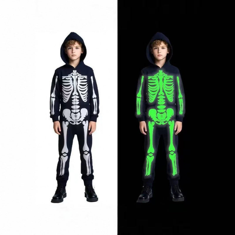 Boy in a black hooded skeleton outfit with white bone print, by day and glowing green in the dark