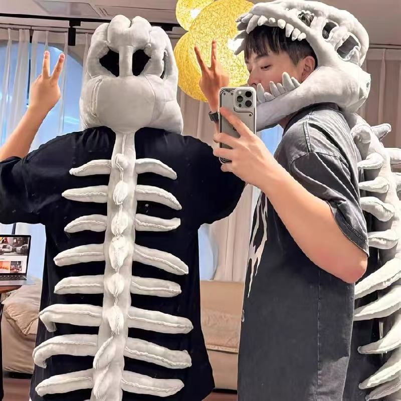 Two people wearing the grey dinosaur skeleton plush hood, shown front and back