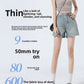 Front view of high-waisted A-line denim shorts in light faded blue on a model