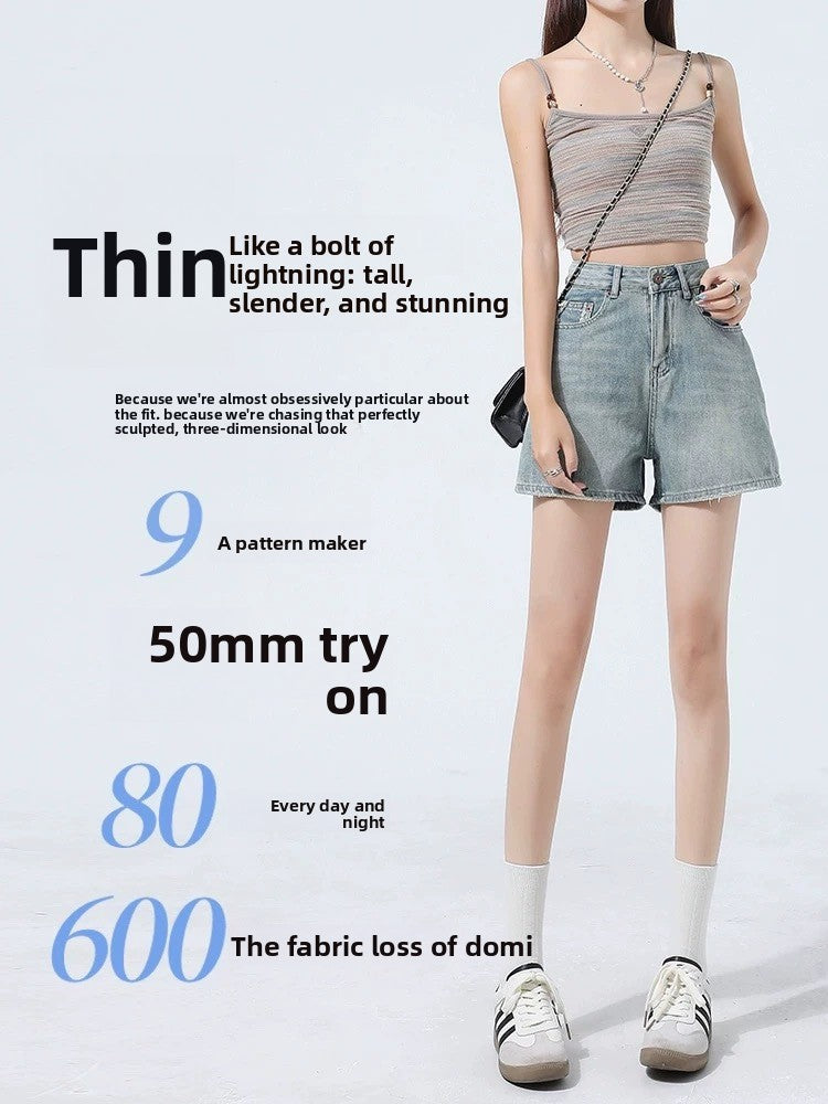 Front view of high-waisted A-line denim shorts in light faded blue on a model