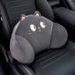 Black cat lumbar support pillow with wide eyes and whiskers resting on a black car seat