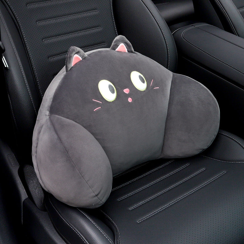 Black cat lumbar support pillow with wide eyes and whiskers resting on a black car seat