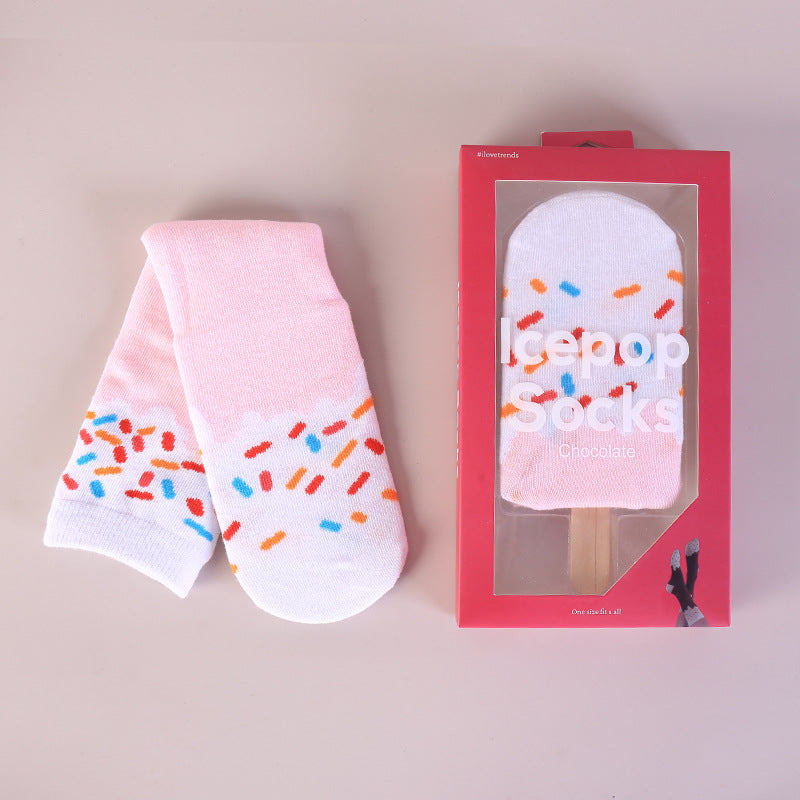 High tube food print crew socks in combed cotton, shown as rolled sushi pieces with toy chopsticks