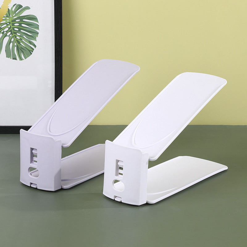 Two white adjustable shoe slot organizers showing the notched height adjustment column