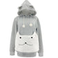Light gray cat ear hoodie with an empty white plush cat face pouch and white pompom drawstrings
