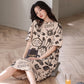 Woman on a cushion in a beige short sleeve nightgown with a black rabbit print and lettering, view 6 of 7