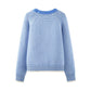 Striped knit women's sweater worn with jeans in an everyday weekend look
