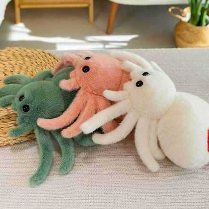 Reversible spider plush flipped to show the grumpy spoof face