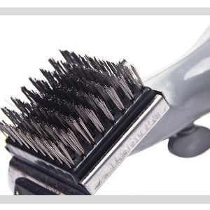 Close view of the stainless steel bristles and metal scraper on the barbecue grill cleaning brush head