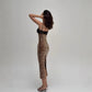 Angled view of the leopard print lace trim dress worn with sandals