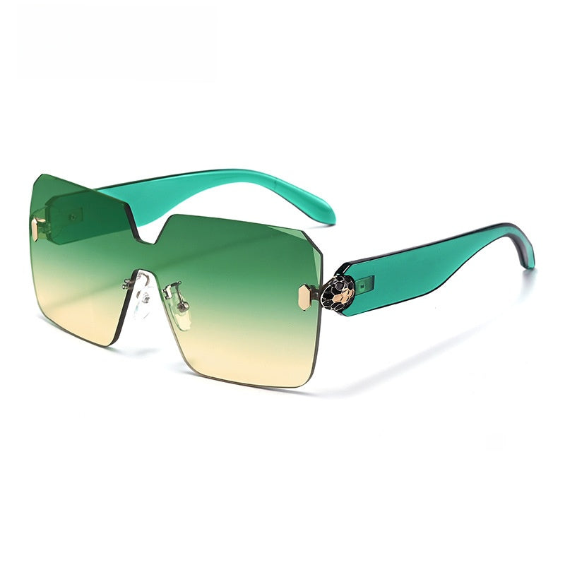 Rimless sunglasses seen from the side, arm meeting the lens at an enamelled hinge