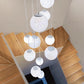 Frosted acrylic globe shades staggered at different heights on cords