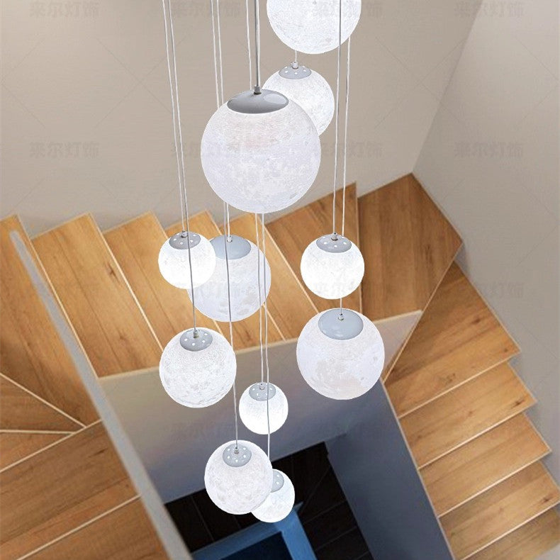 Frosted acrylic globe shades staggered at different heights on cords