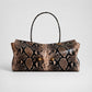Pink and brown snake print shoulder bag with gold ball studs, shown for the Pink option